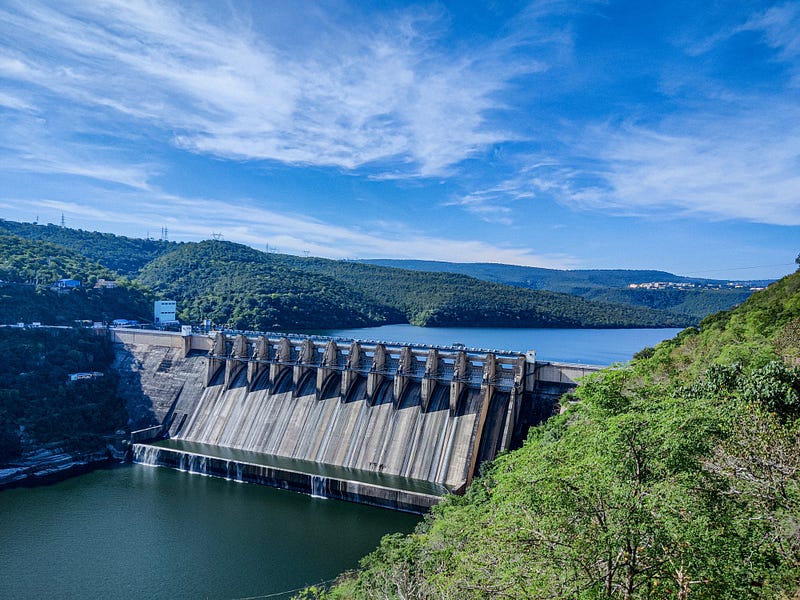 Aerial view of a large dam in a mountainous region